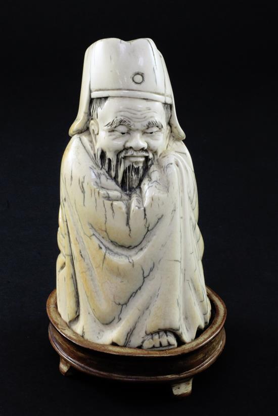 A Chinese mammoth ivory tusk carving of a seated figure of Li Bai, 20th century, 14cm, wood stand